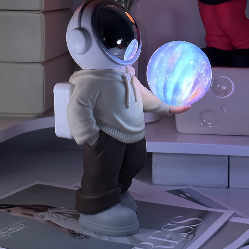 Holding a dreamy starry sky (beige top + brown pants) Creative Astronaut Bluetooth Speaker with 3D Starry Sky Lighting,