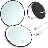 Double-sided makeup mirror with 10x magnifying LED lighting and adjustable brightness. Small, illuminated mirror with adjustable intensity, ideal for handbags. Black.