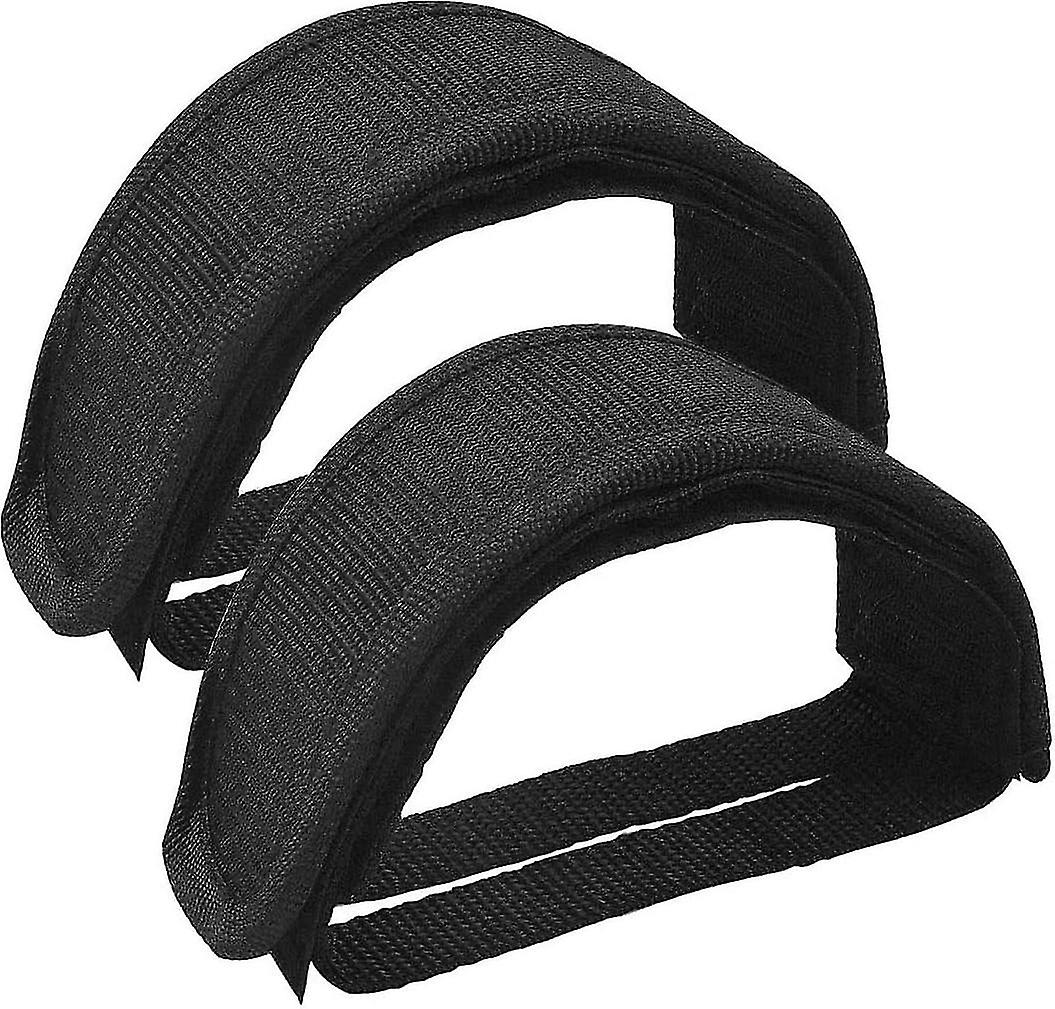 Black nylon bicycle pedal straps with adjustable straps.
