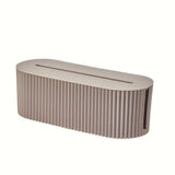 Light brown cable storage box with lid, showing openings for cables.