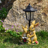 Solar Simulation Rabbit Ornament, charges by day and lights up automatically at night, three rabbits cluster around a street lamp with "WELCOME" bucket, warmly decorates courtyard and balcony, eco-friendly and healing./Rabbit's Kin