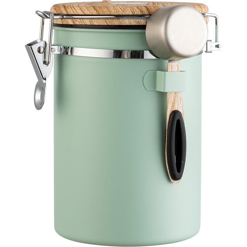 Green stainless steel coffee container with airtight lid.