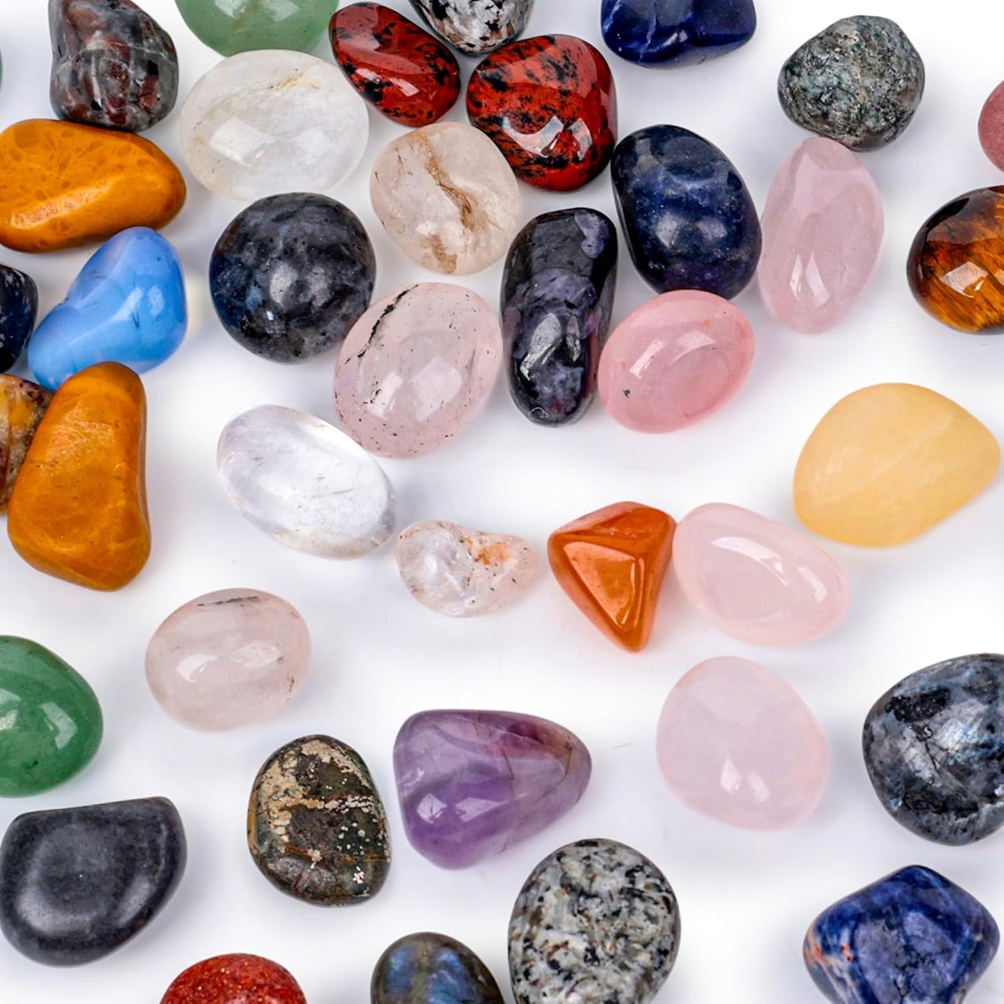 Assorted natural tumbled stones in various colors and sizes.
