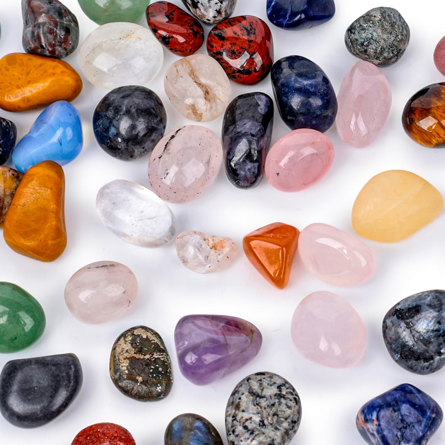 Assorted natural tumbled stones in various colors and sizes.