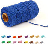 Deep blue cotton baker's twine rope coiled on a white surface.