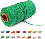 Deep green cotton baker's twine rope coiled on a white surface.
