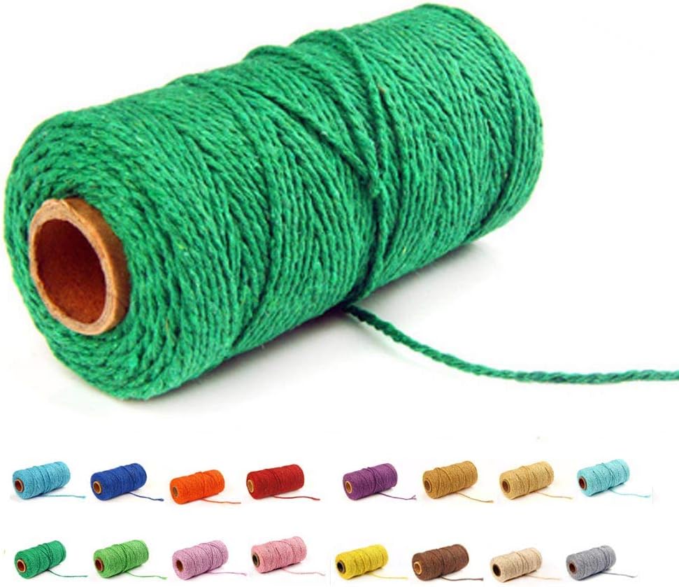 Deep green cotton baker's twine rope coiled on a white surface.
