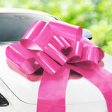 Pink 30-inch diameter car bow with two gold accessory bows.
