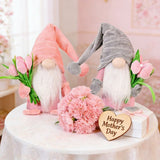 1pc Plush standing gnome doll — faceless old man figurine, festive tabletop ornament and gift.Pink faceless old man gnome holding a bouquet