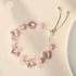 Silver-tone bolo bracelet with clear crystal beads and four-leaf clover charms.