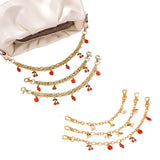 Three-layered ceramic bag charm with ethnic design and metal accents.