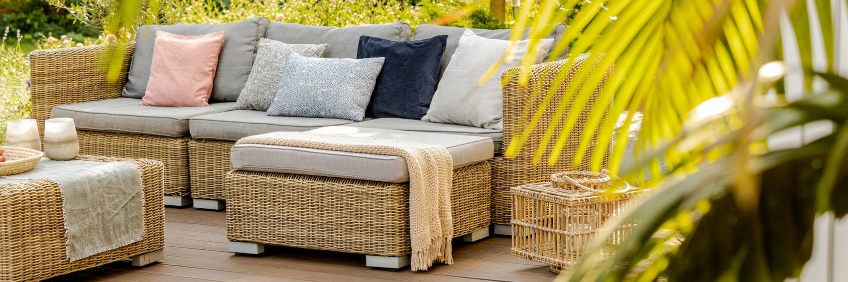 Outdoor patio furniture set with cushions on a wooden deck